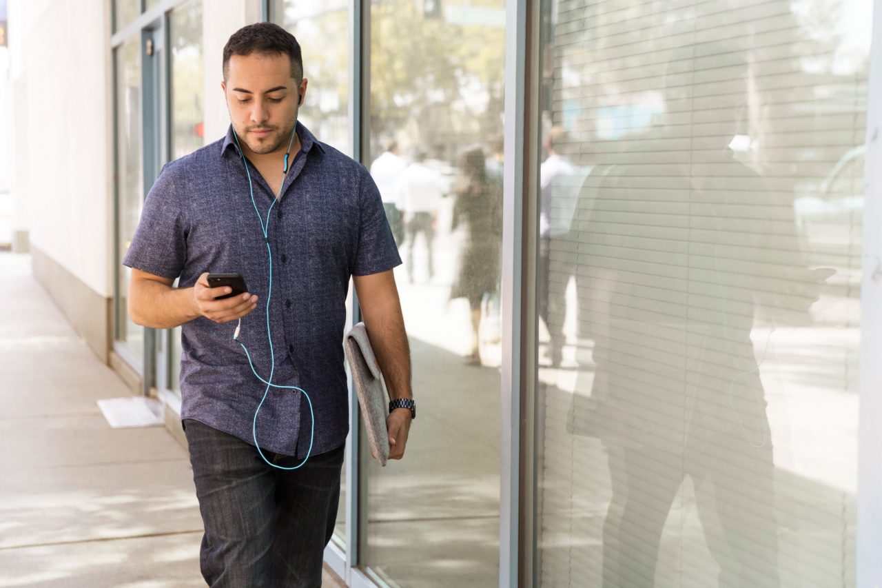 Man walking while looking at cellphone