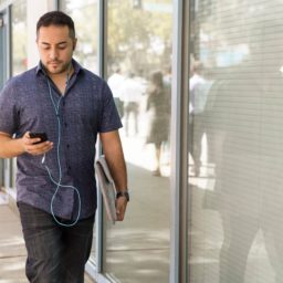 Man walking while looking at cellphone