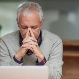 Man presses his fingers to his nose that is in pain or is stuffy