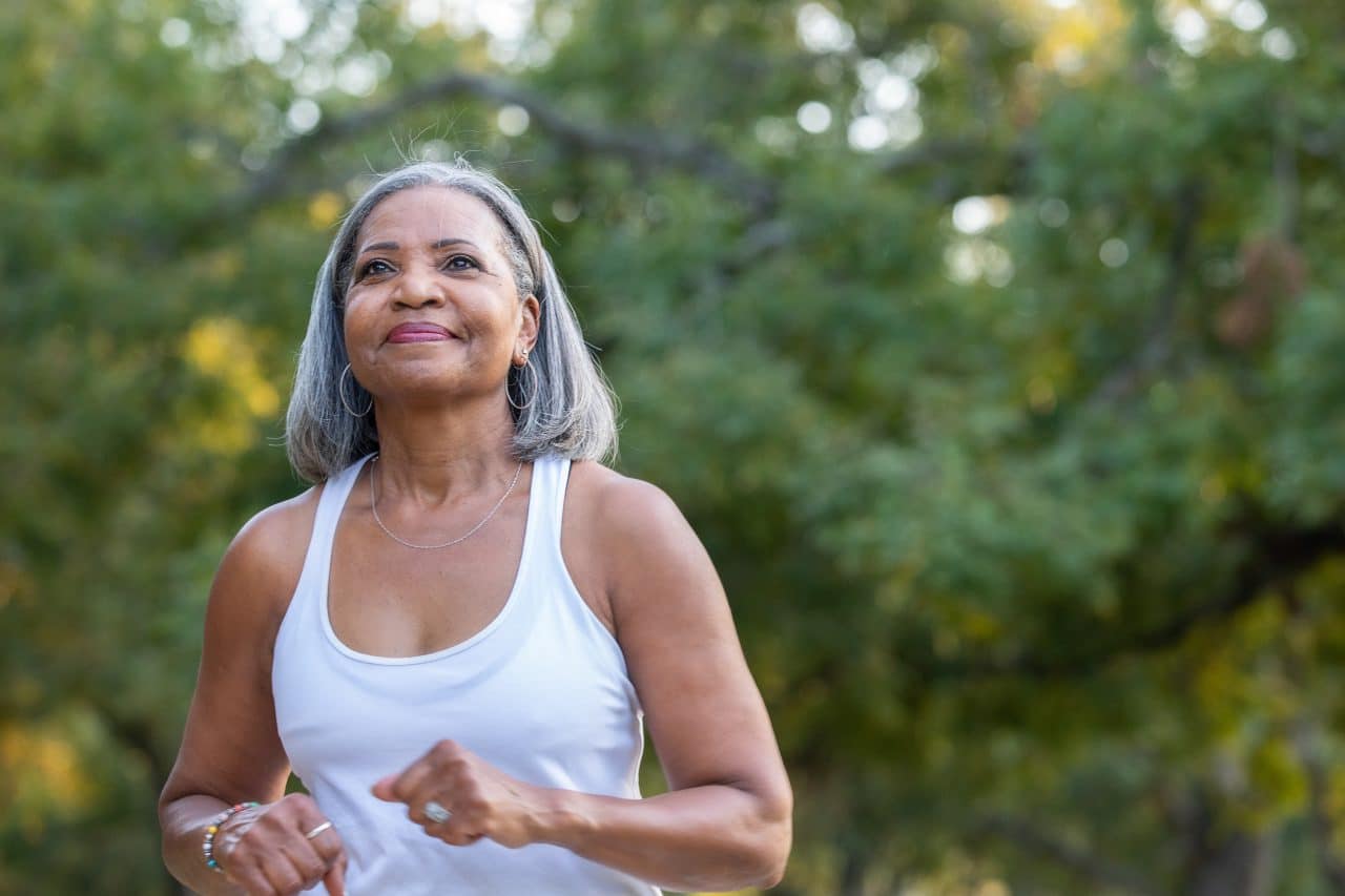 Older woman exercising outdoors.