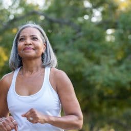 Older woman exercising outdoors.