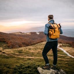 Camper enjoying nature sights and sounds outdoors.