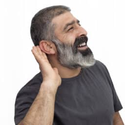 Happy man with a hand to his ear