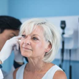 ENT examining a woman's ear