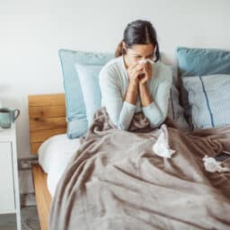 Woman in bed, sick with a virus.
