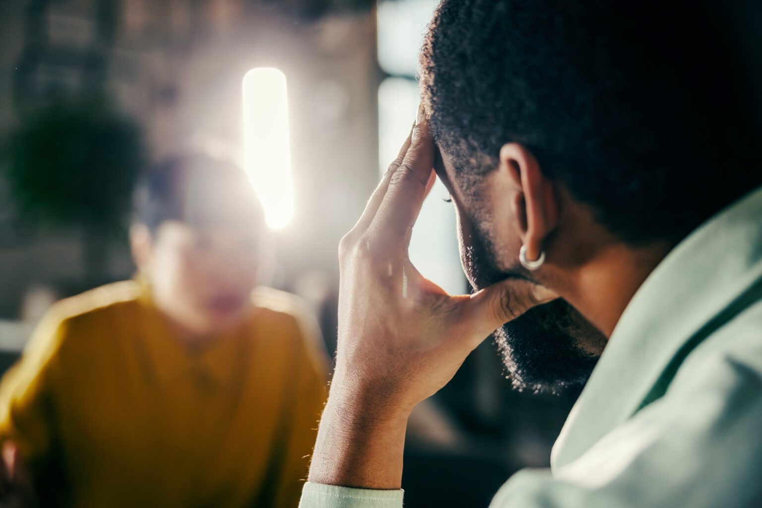 Man feels fatigue during a conversation, which could indicate hidden hearing loss.