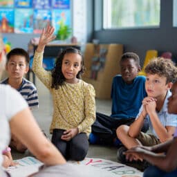 Kids during circle time at school, listening attentively and participating.