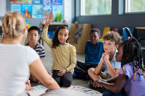Kids during circle time at school, listening attentively and participating.
